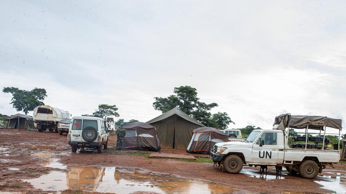 UN vehicles parked outside of tents.