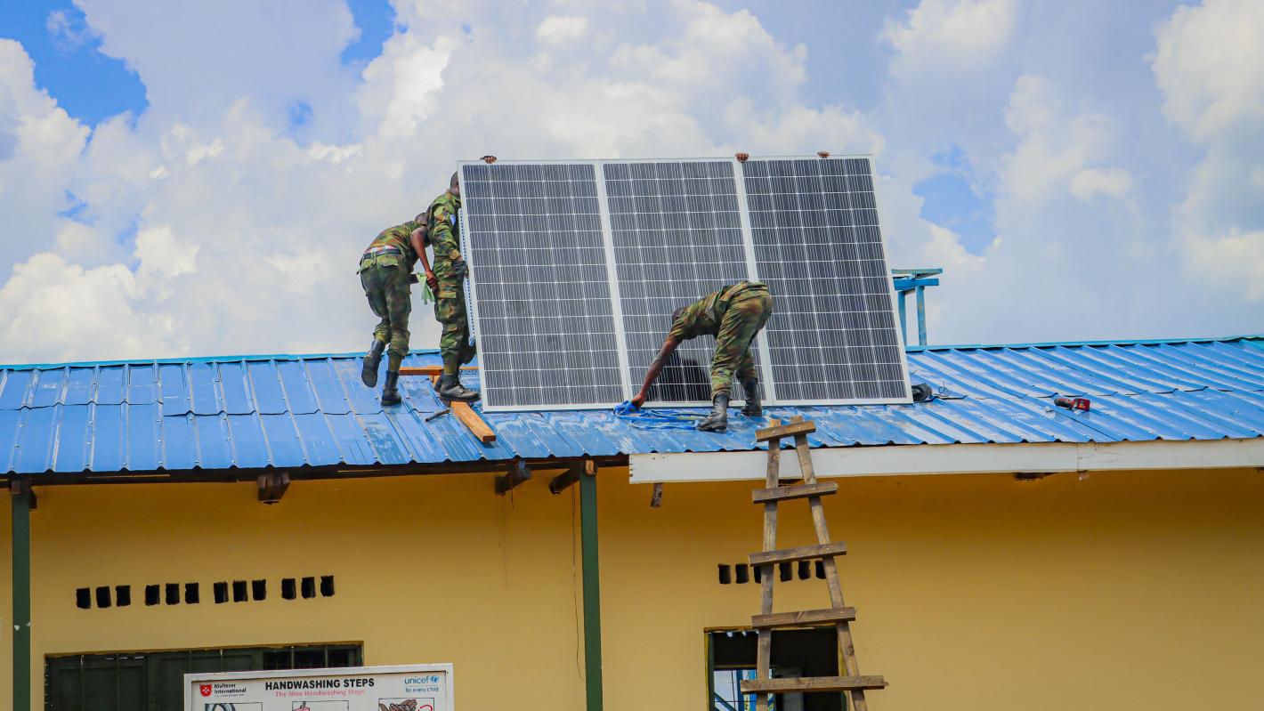 peacekeepers setting up solar panels