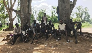 A community of local boys and youth, age 12-25 seated at the banks of the Kineti River in Torit, South Sudan waiting for a customer for their “car wash” business. They forgo their schooling to gain a living at 300SSPs per car.