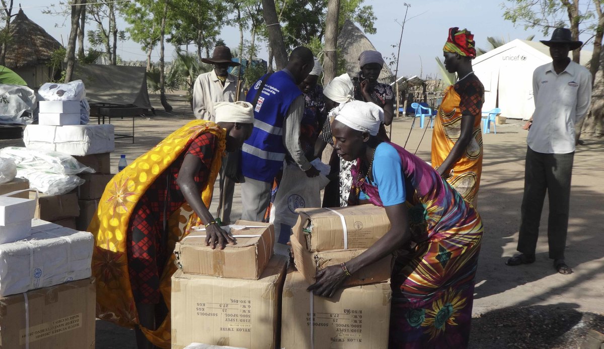 Women recieve boxes of Fishing Kits distributed by FAO