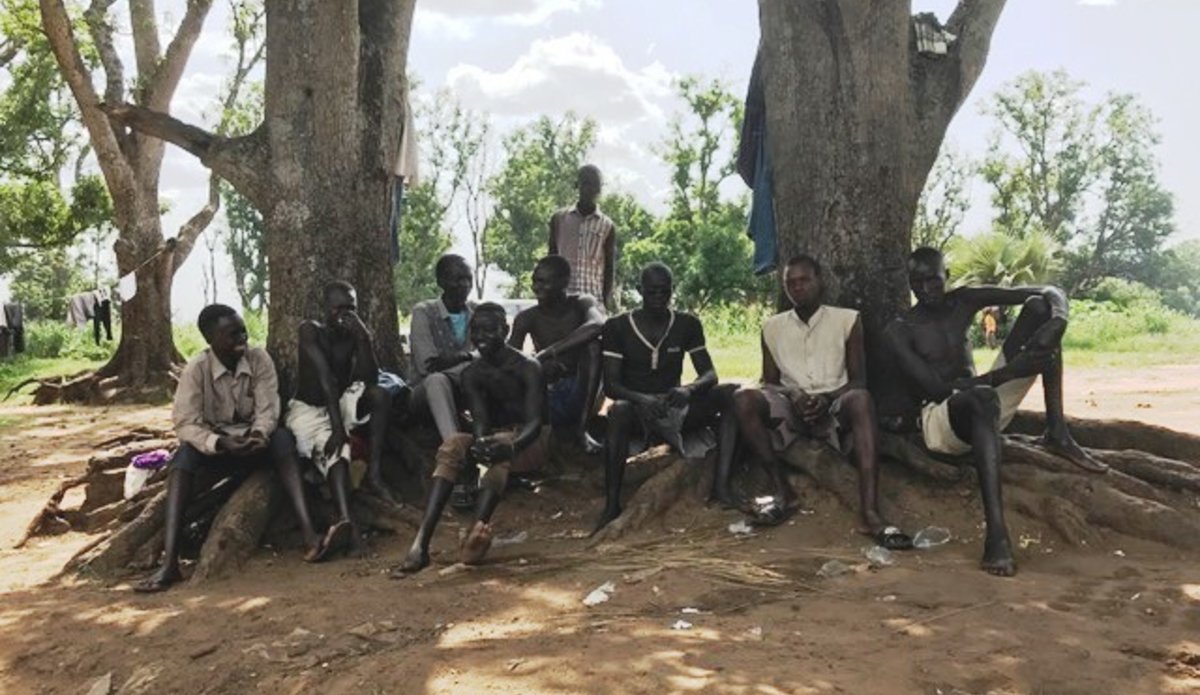 A community of local boys and youth, age 12-25 seated at the banks of the Kineti River in Torit, South Sudan waiting for a customer for their “car wash” business. They forgo their schooling to gain a living at 300SSPs per car.