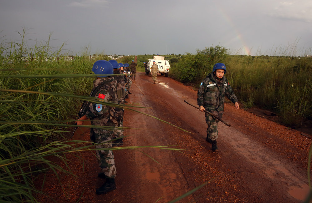 UNMISS Peacekeepers perform weapons sweep on the outskirts of PoC site 3, Juba