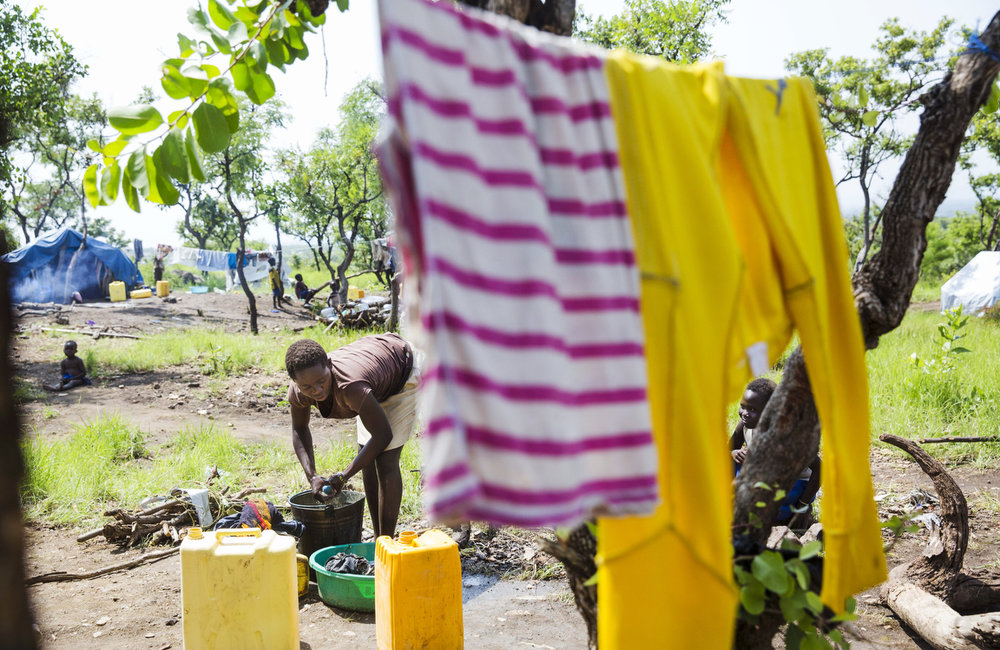 Gladys Joy does washing for her family of six while at the Imvepi Refugee camp in Northern Uganda on Saturday, 24 June, 2017.   Gladys’ family fled their home in Yei, South Sudan after a surge in violence in March.  Many of the new arrivals are from the Yei River State, know to be an ethnically diverse area and the breadbasket of South Sudan.  An UNMISS Human rights reports states that the region experienced an outbreak of ethnically motivated violence in 2016, displacing 70 percent of the population.