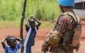 Peacekeeper with children at UNMISS base in Wau