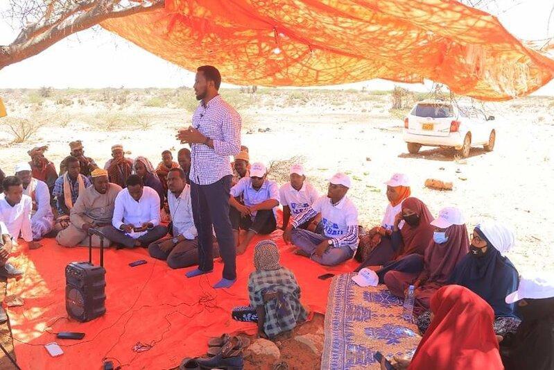 Mohamed Sheikh Said Haji speaks to a group, which consists of both men and women Mohamed Sheikh Said Haji speaks to a group, which consists of both men and women